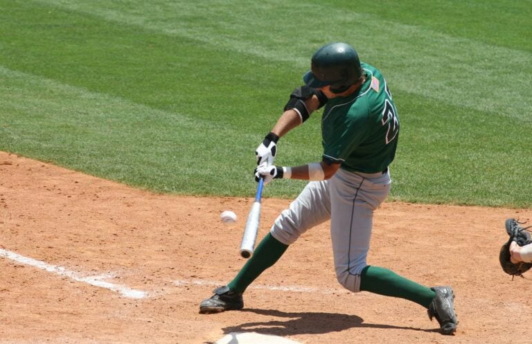 A baseball player swinging a bat at a ball.