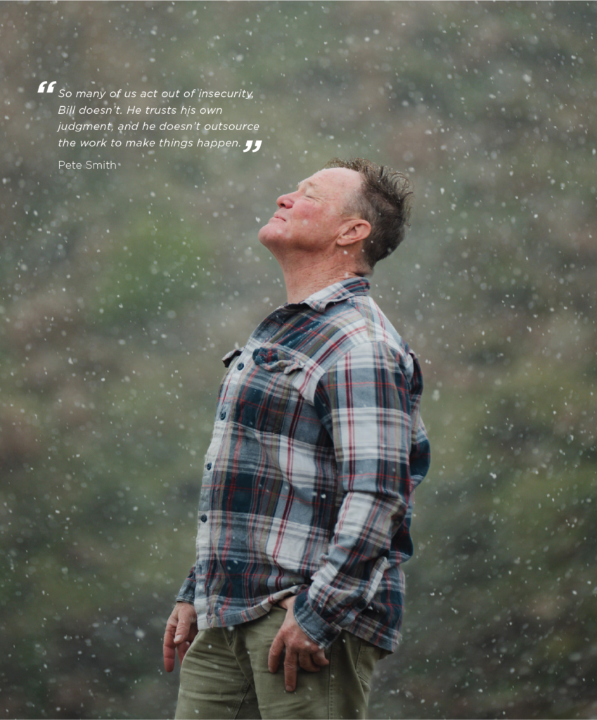 Bill Kerig smiles up at the snow in Antelope Island State Park, wearing a flannel and khakis.