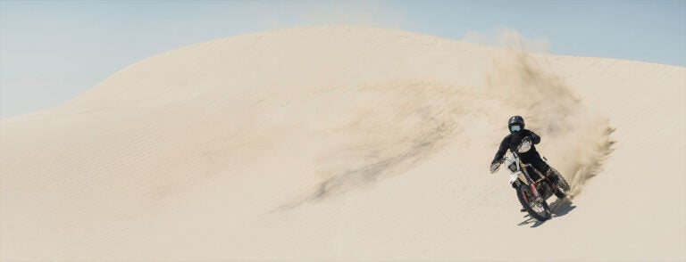 Bill Kerig rides his motorcycle across the sand dunes of southern Utah